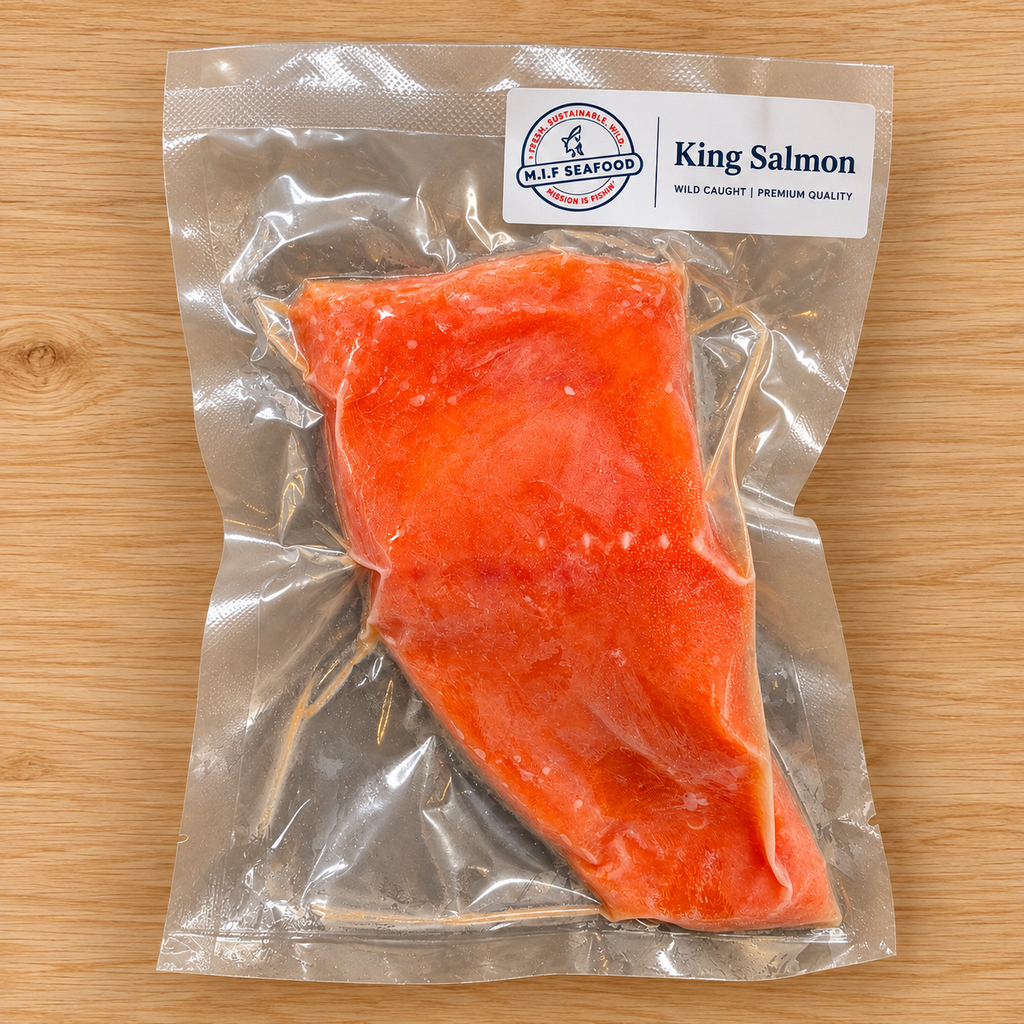A vacuum-sealed package of King Salmon from M.I.F Seafood, showing the bright orange-red raw salmon fillet inside a clear plastic bag on a light wood background.